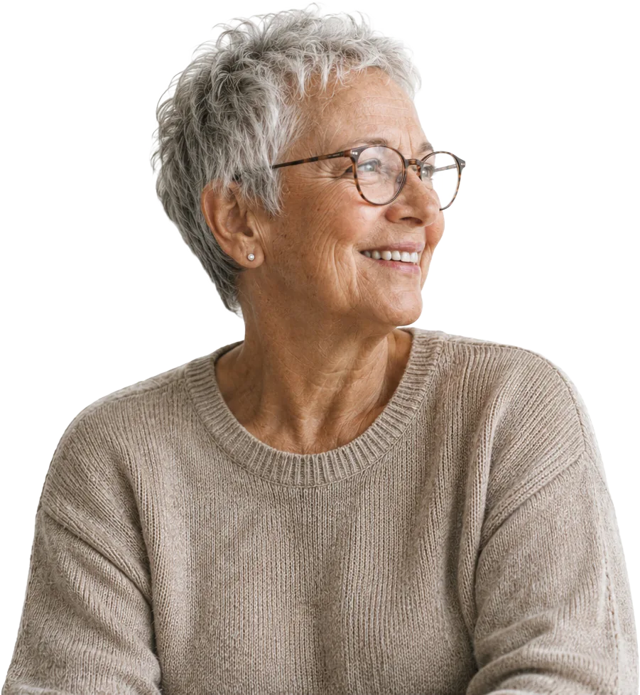 An older woman smiling, looking into the distance